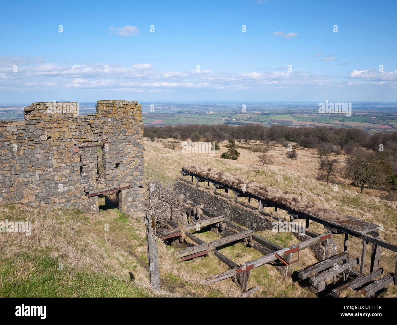 Rock crushing house ruins in dolerite (dhustone) quarry workings on Abdon Burf, the summit of Brown Clee, Shropshire Stock Photo