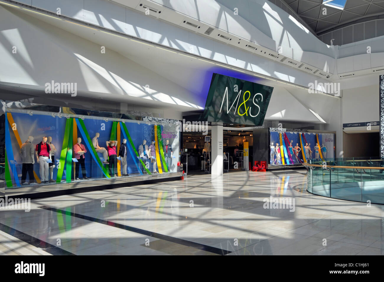 Marks and Spencer retail store window displays & M&S sign above entrance inside Westfield shopping centre Shepherds Bush White City London England UK Stock Photo