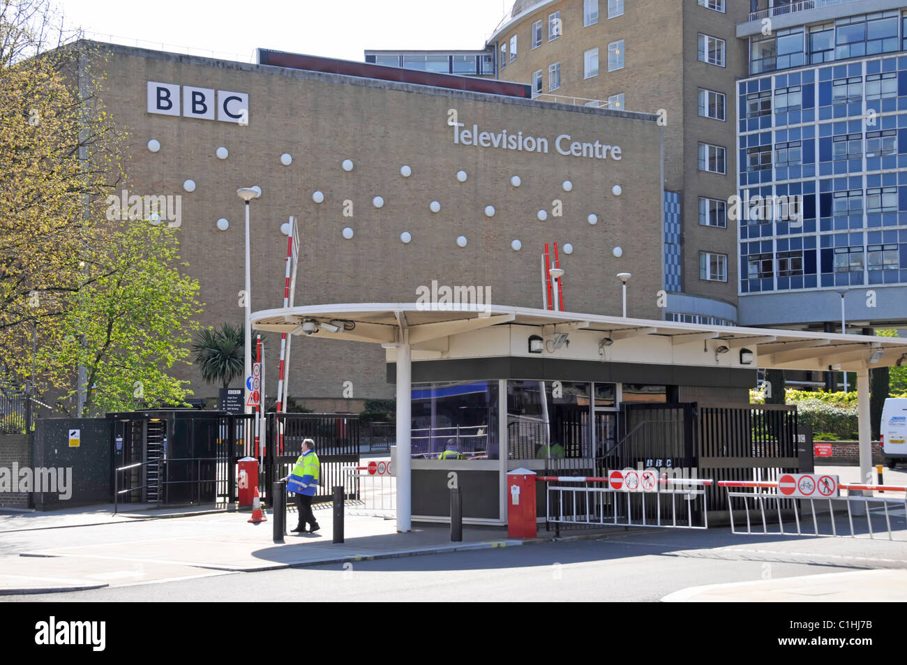 London street scene entrance to BBC Television Centre building with security gatehouse for vehicle exit & entrance White City London England UK Stock Photo