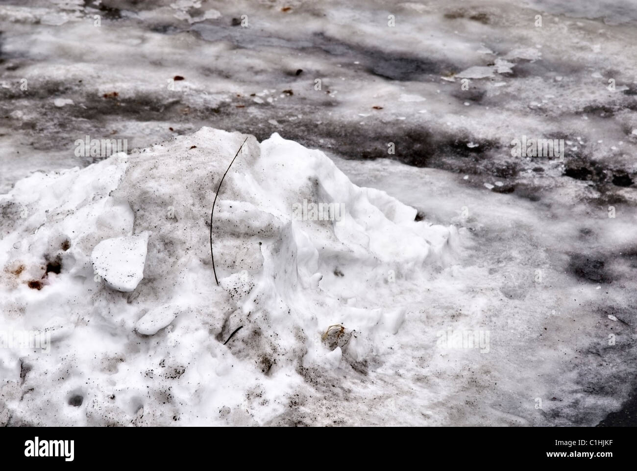 Pile of dirty thawing snow slush and ice on the road side Stock Photo ...