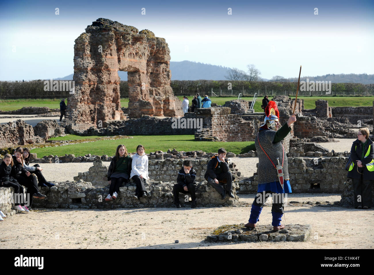A guide wearing Roman uniform talking to school children at Wroxeter or 'Viroconium' in Shropshire Stock Photo