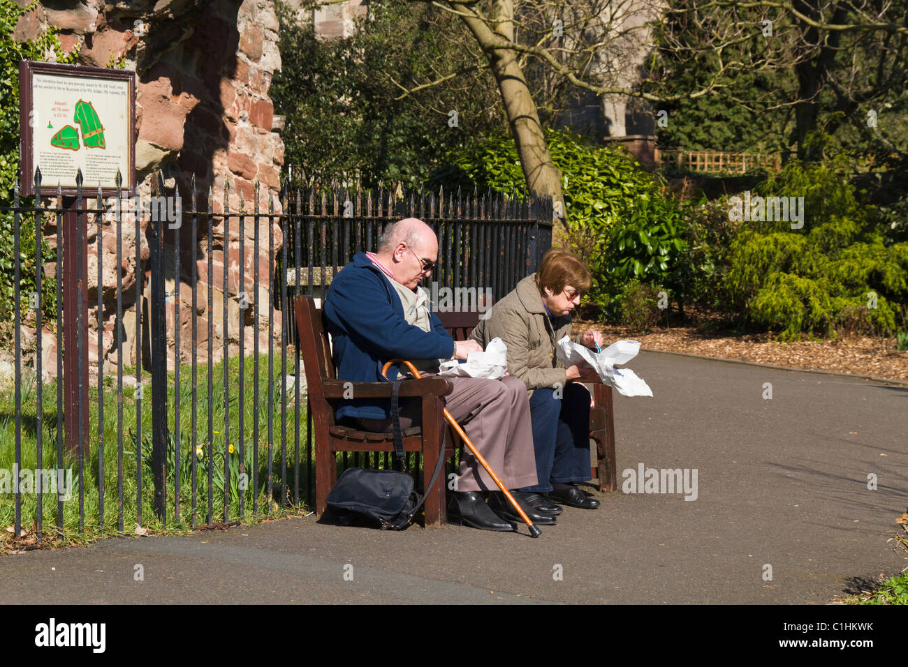 Elderly couple eating fish and chips on a bench Stock Photo