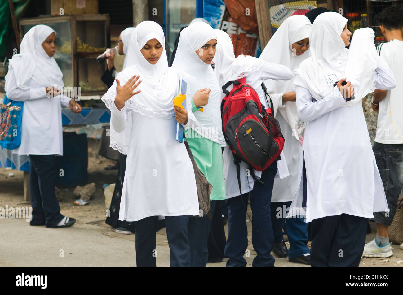 Street scene with schoolgirls, Zanzibar, Tanzania Stock Photo