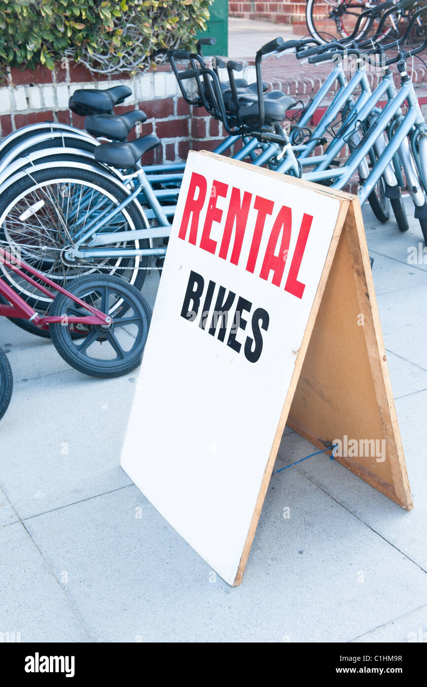 A rental bike display sign with tandem bikes in back. Designer can ...
