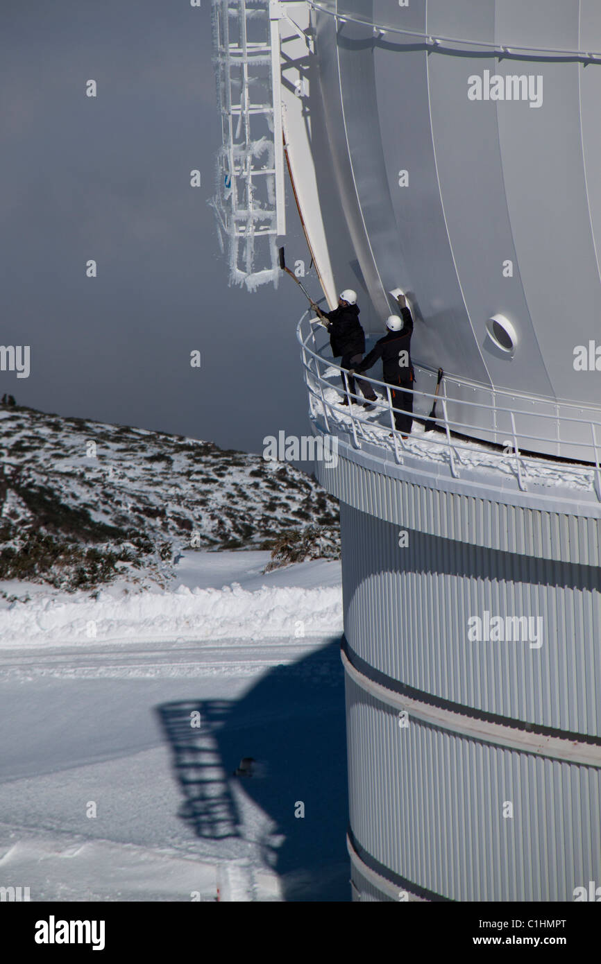 The operation team is cleaning the telescope dome from ice and snow in the wintertime at the WHT (La Palma, Spain). Stock Photo