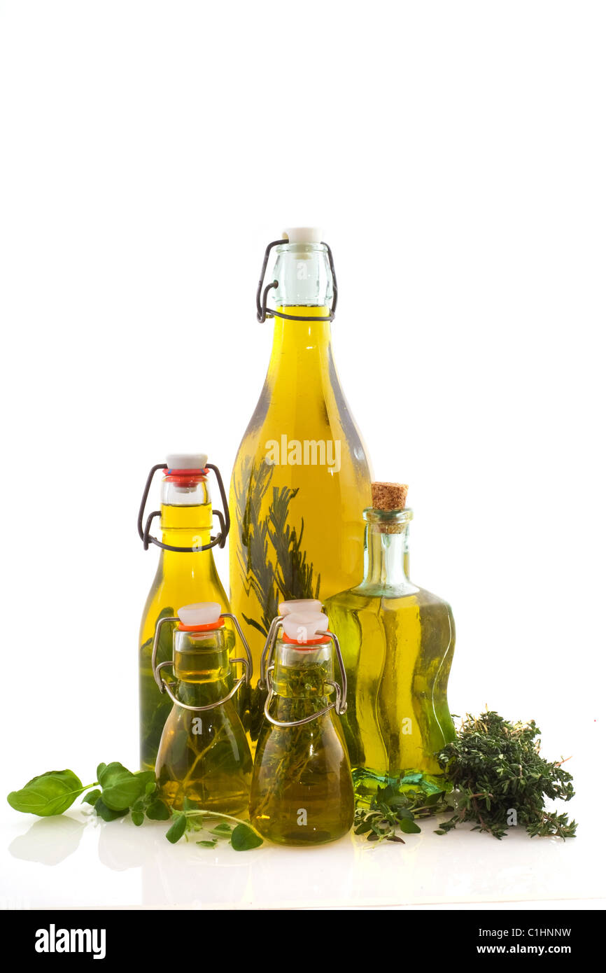 bottles olive oil with herbs inside and fresh Stock Photo - Alamy