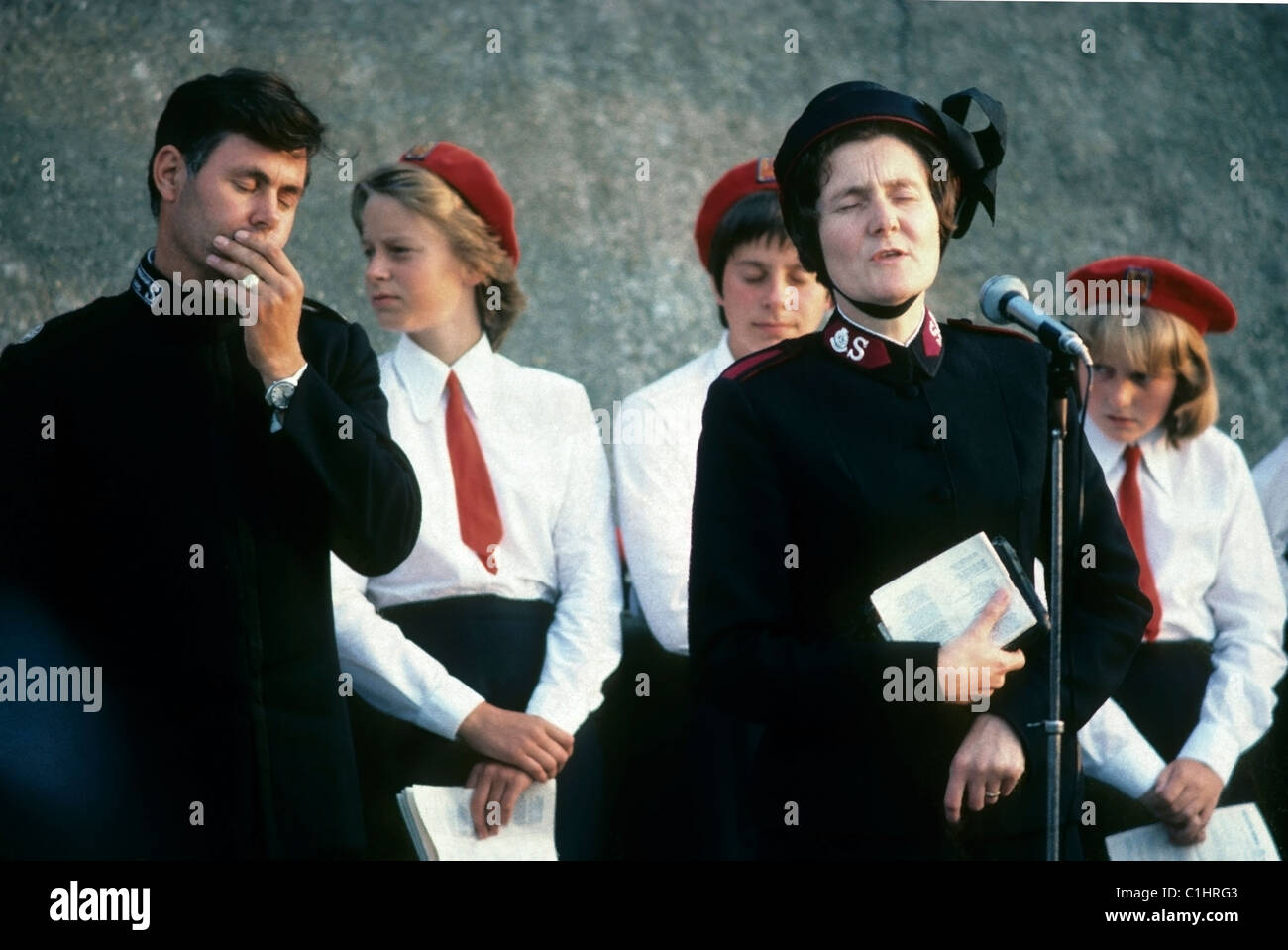 Members man and women of the Salvation Army band in uniform praying and speaking on the streets in Norfolk England UK 1970s 1973  70s seventies   KATHY DEWITT Stock Photo