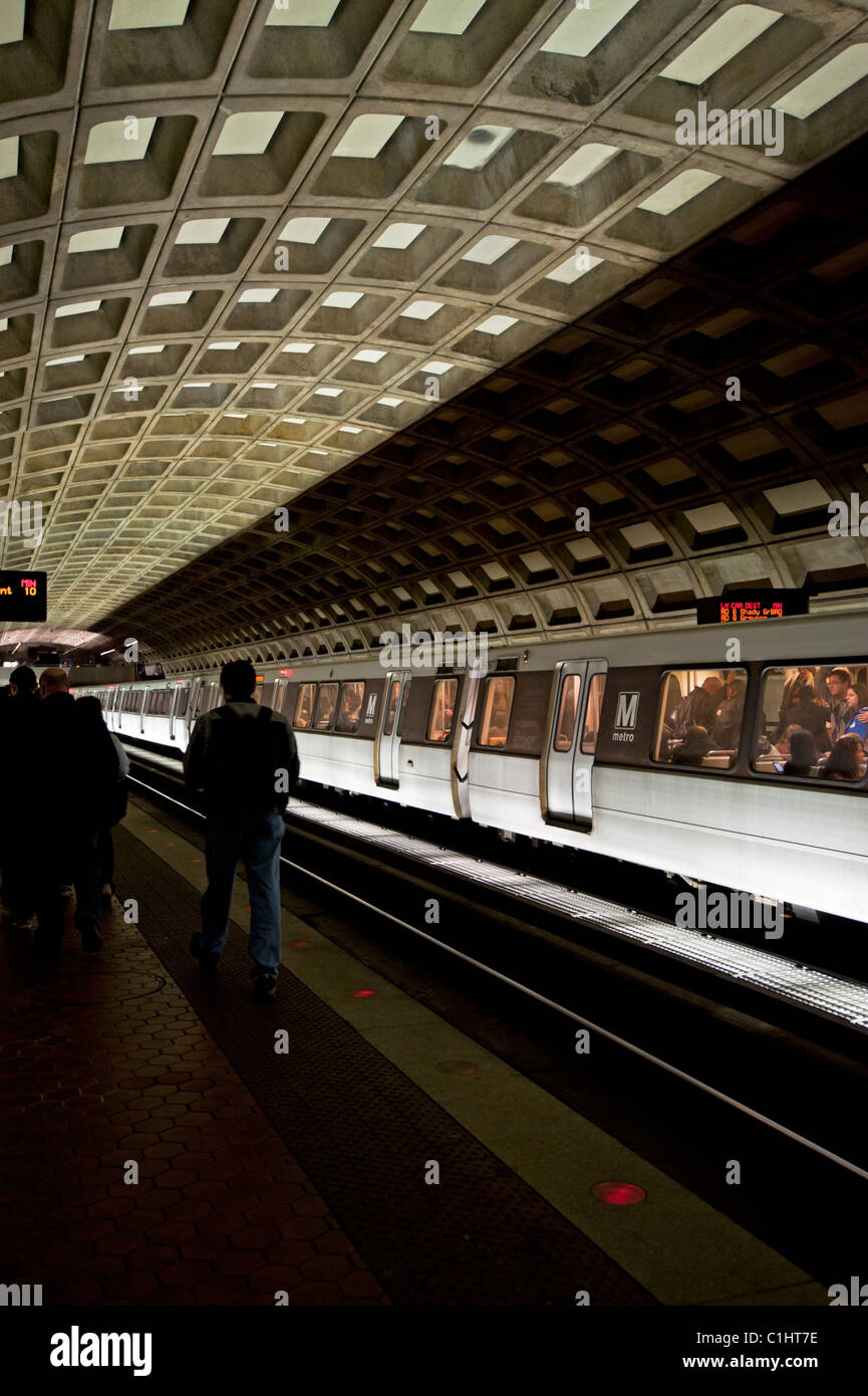 The Washington DC subway Metro Rail train and tunnel with people along the tracks. Stock Photo