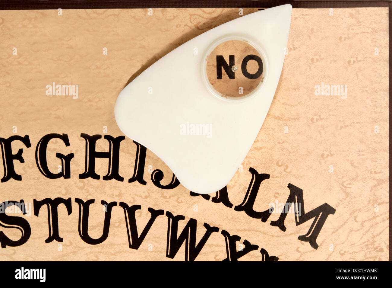 Ouija board with the planchette pointing to NO Stock Photo
