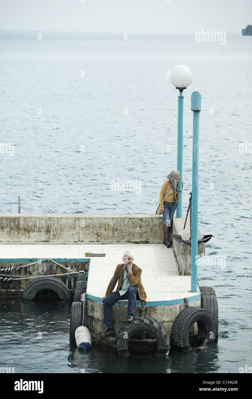 Senior couple on a pier, Italy Stock Photo