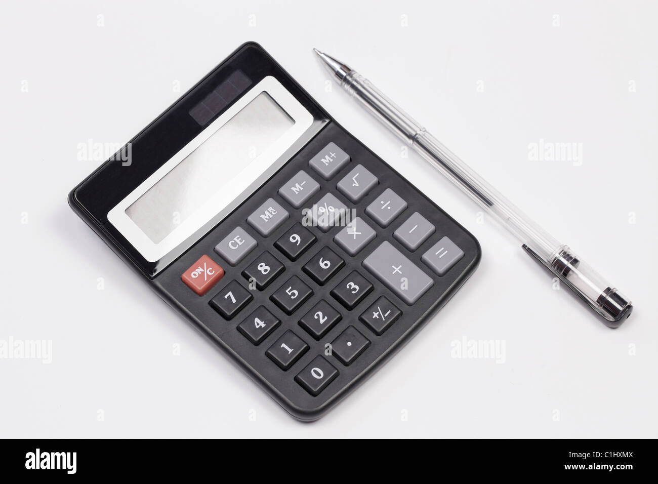 Large size electronic calculator with a ball point pen on a white background Stock Photo
