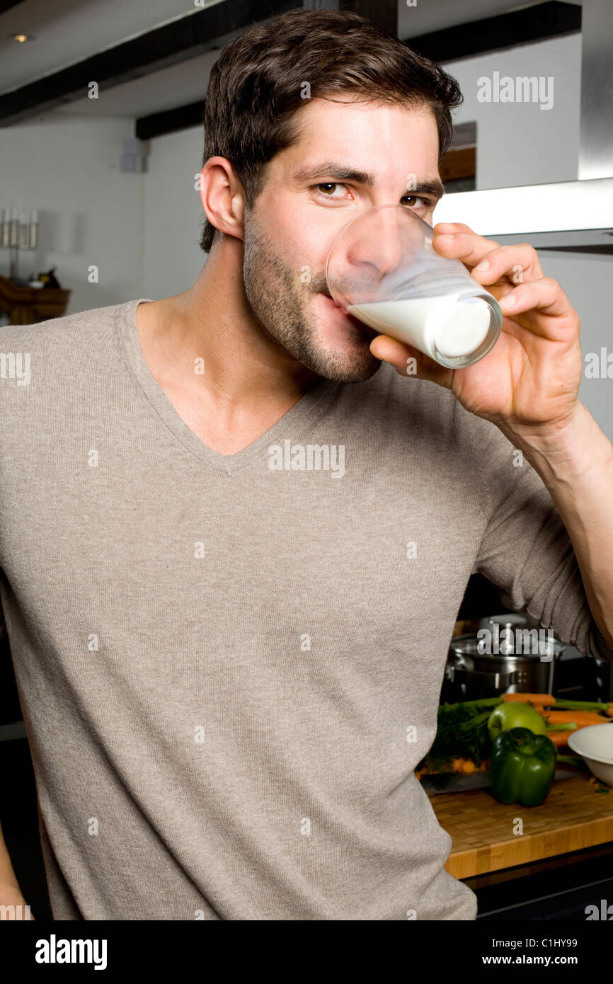 Young man drinking milk Stock Photo