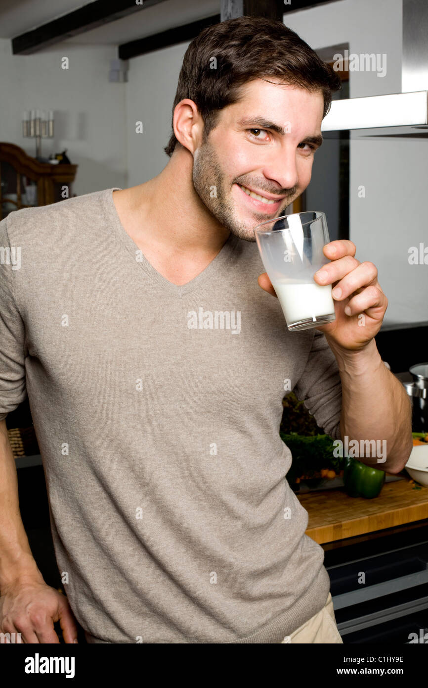 Young man drinking milk Stock Photo