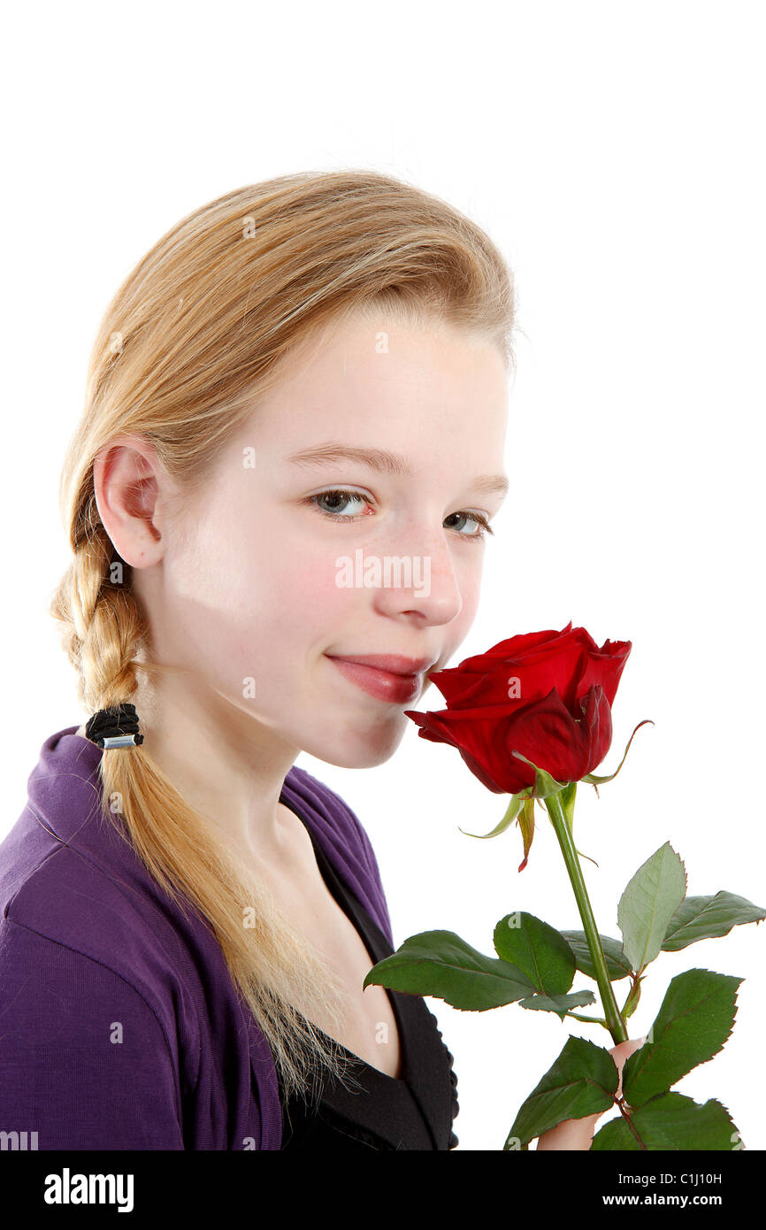 young girl smelling a red rose in closeup over white background Stock ...