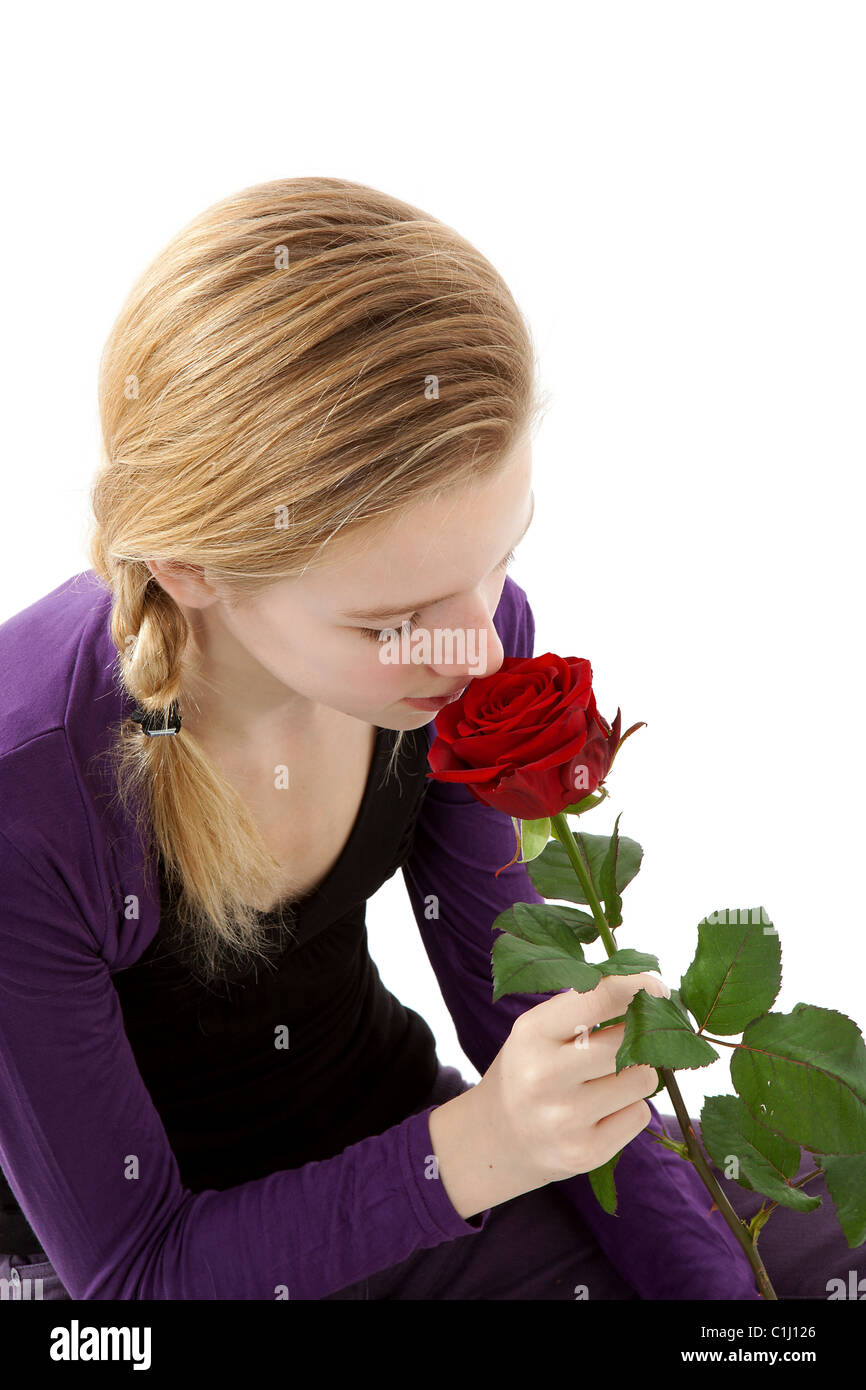 young girl smelling a red rose in closeup over white background Stock ...