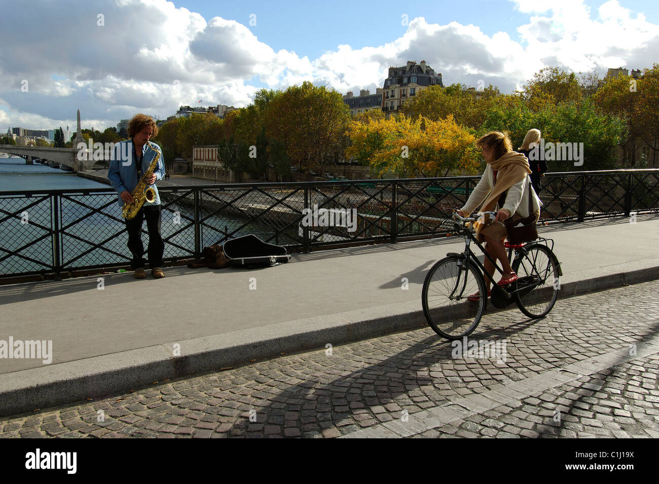 France, Paris, saxophone player on the archbishop bridge behind Notre Dame Stock Photo