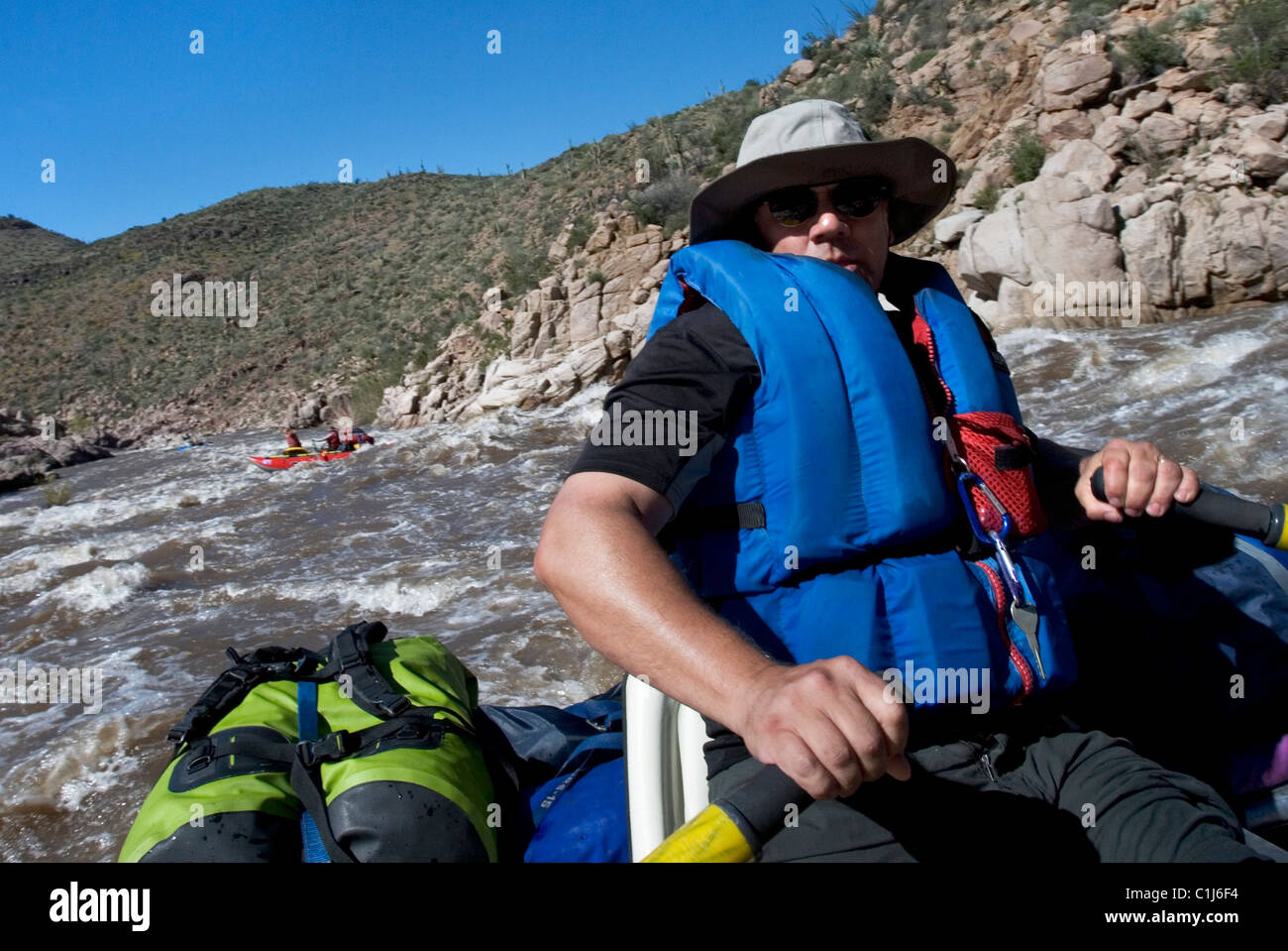 A man rafting on the Salt River in Arizona, USA on an inflatable pontoon boat. Stock Photo
