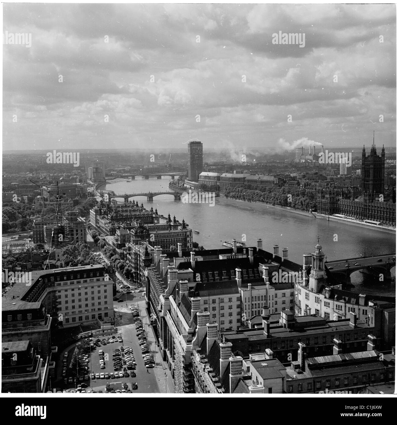 1960s, aerial view of River Thames from County Hall, showing the Victoria tower of the Palace of Westminster and Millbank, a modern tower block. Stock Photo