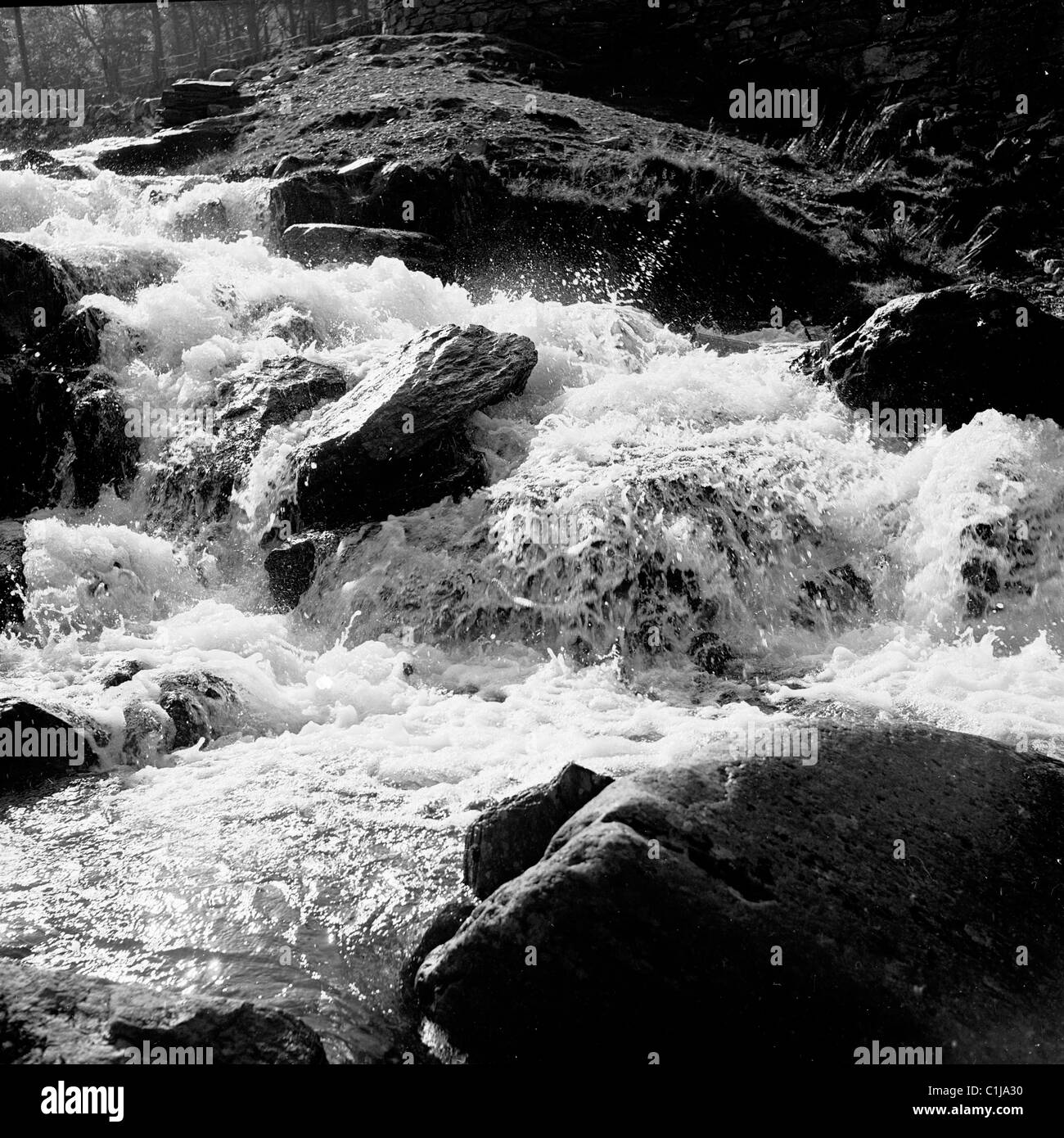 1950s, historical, fast flowing river, water going over rocks, Wales, UK. Stock Photo