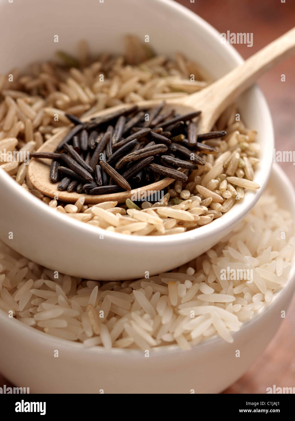 Wild rice brown rice and Basmati in measuring cups Stock Photo