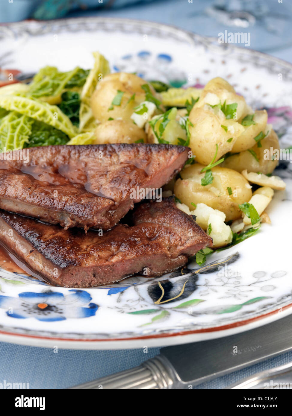 Calves liver with cabbage and potatoes Stock Photo