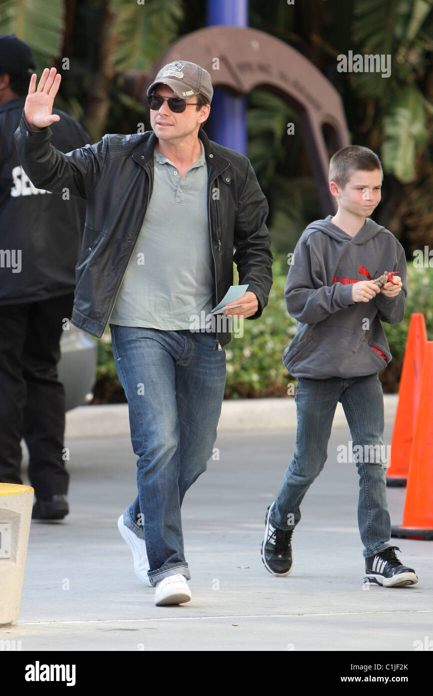 Christian Slater and his son Jaden, arrive for the first game of the