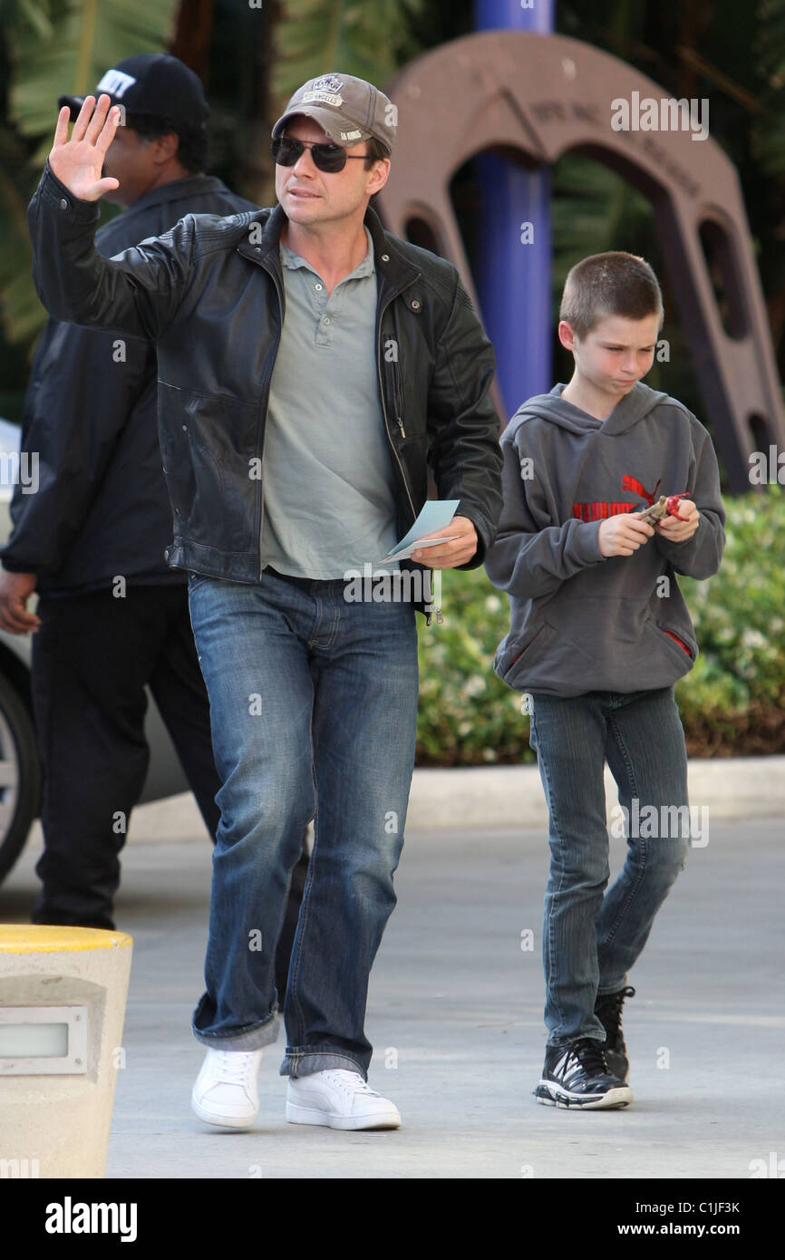 Christian Slater and his son Jaden, arrive for the first game of the