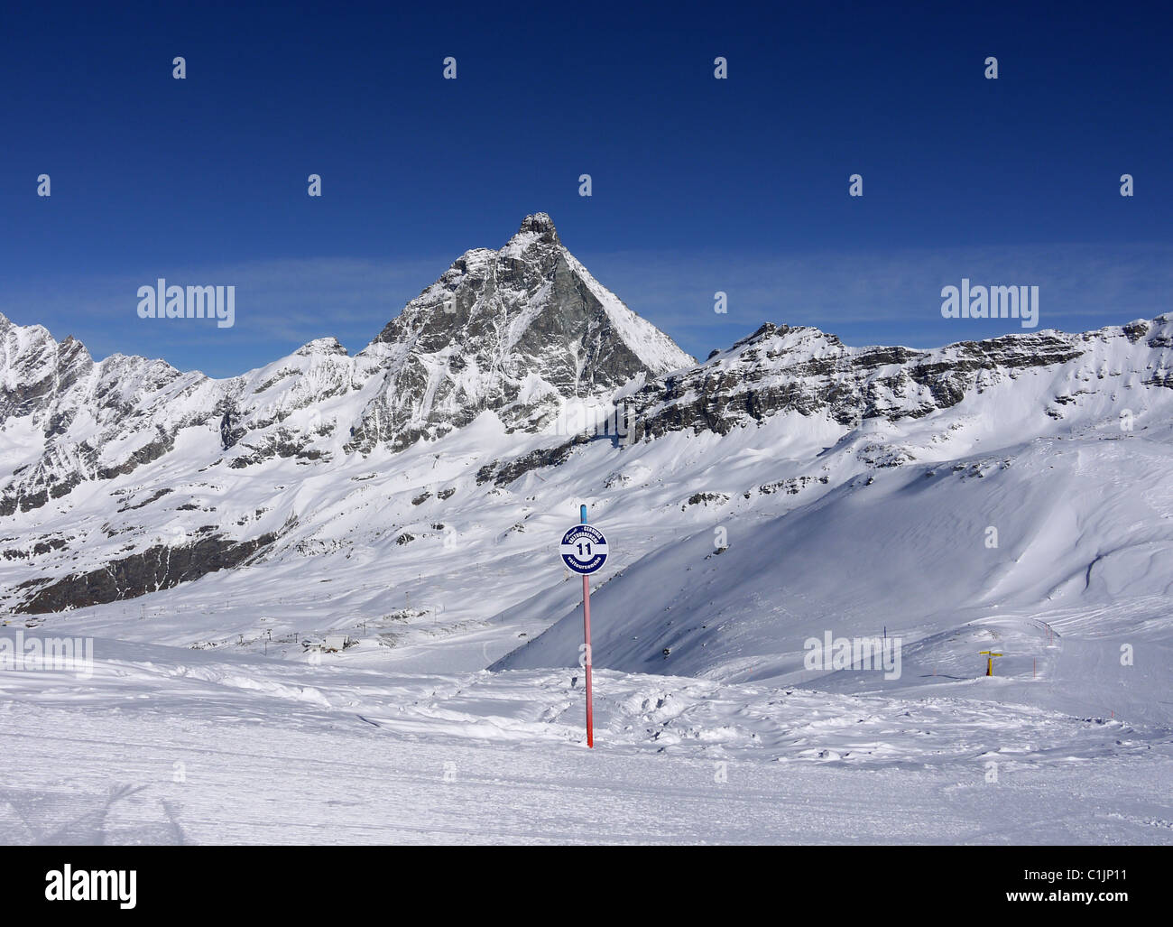 Start of the long ski down to Val Tournache, Italy from  Cervinia with the Monte Cervino in the background aka Matterhorn Stock Photo
