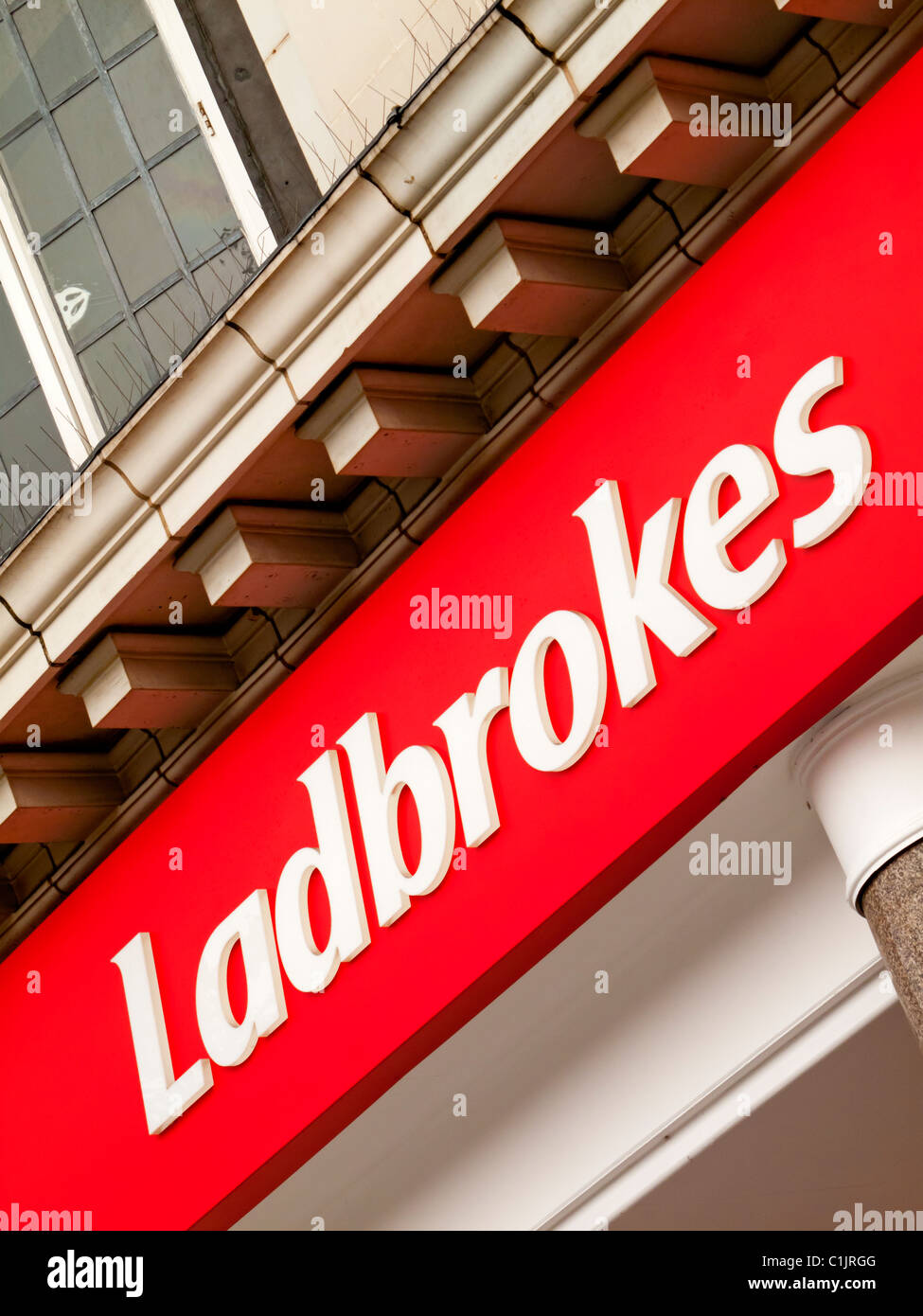 Sign outside Ladbrokes betting shop a UK based retail bookmaker with over 2400 branches Stock Photo