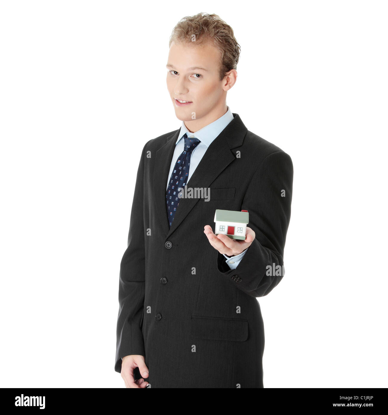 Young businessman with house model on hand- real estate concept ...