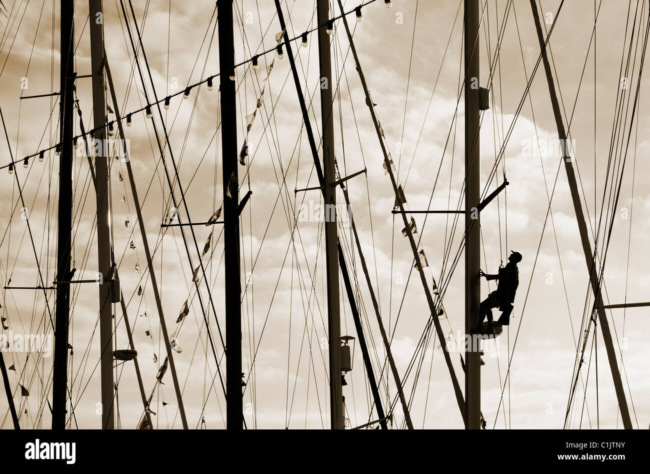Sailor climbing yacht mast Stock Photo Alamy