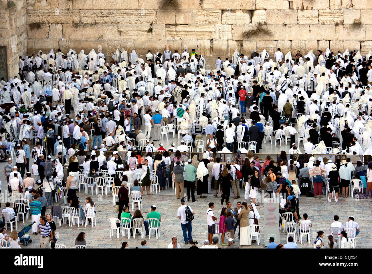 Jewish religious man with traditional clothes pray at the Wailing Wall