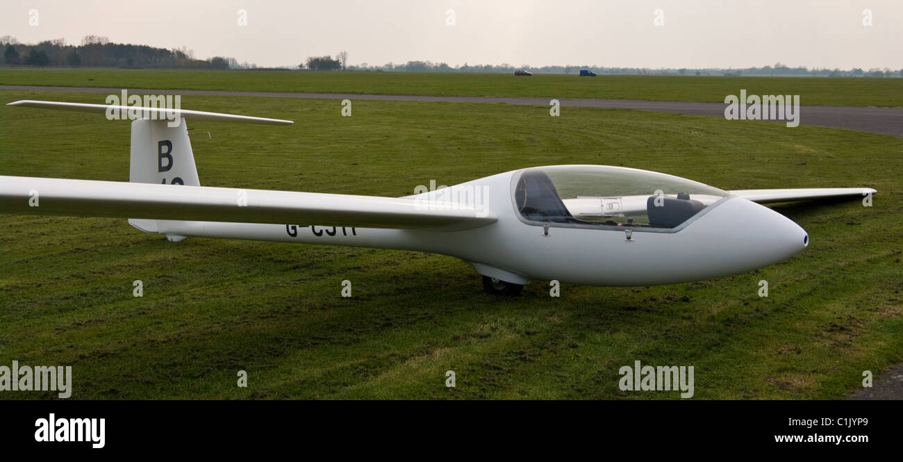 One man - Solo Glider resting on airfield grass Stock Photo