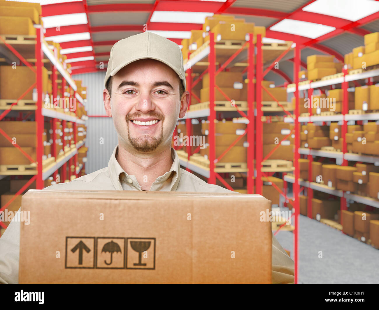 smiling young delivery man in modern warehouse Stock Photo - Alamy