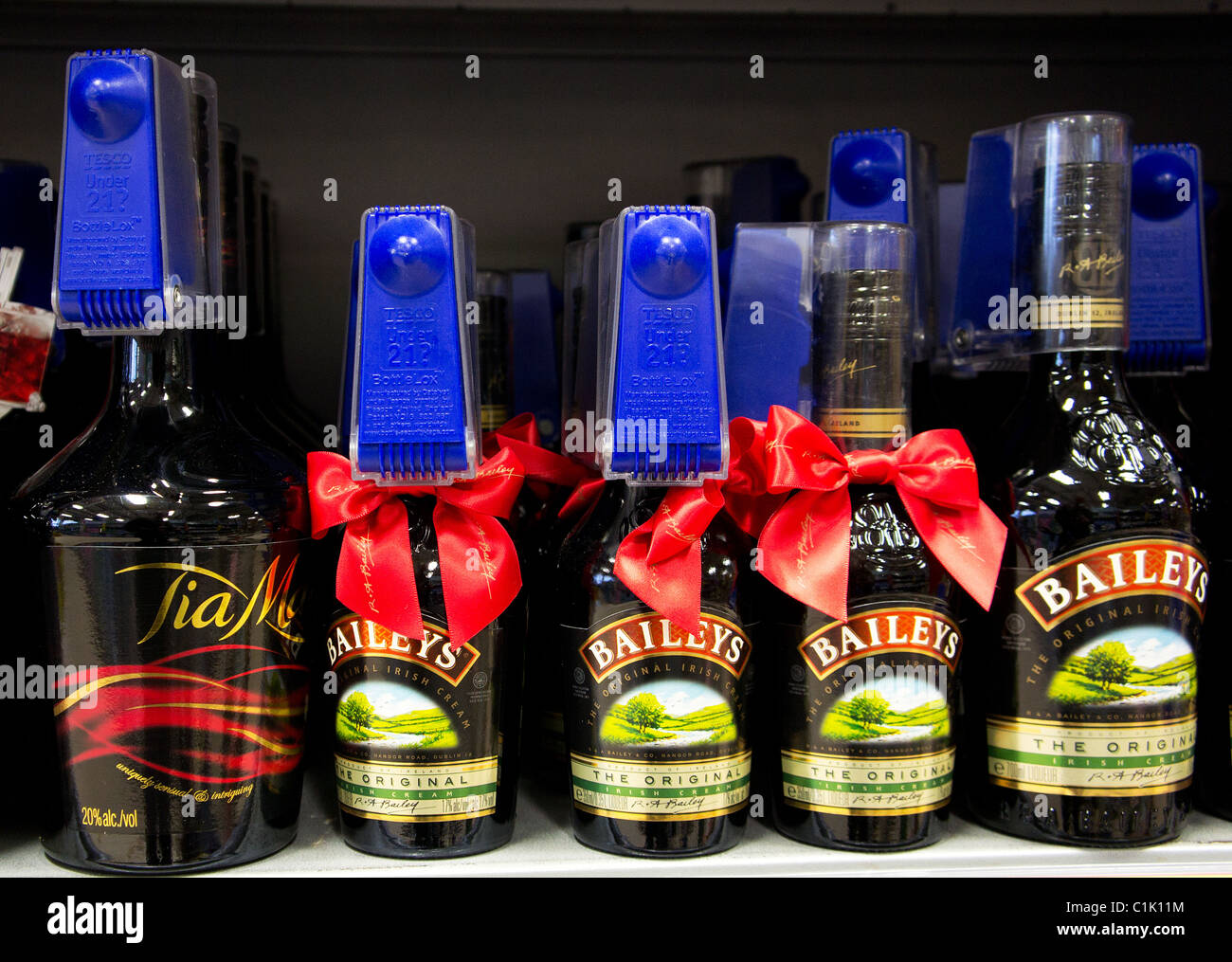 Bottles of Baileys liqueur security tagged in a UK supermarket Stock Photo