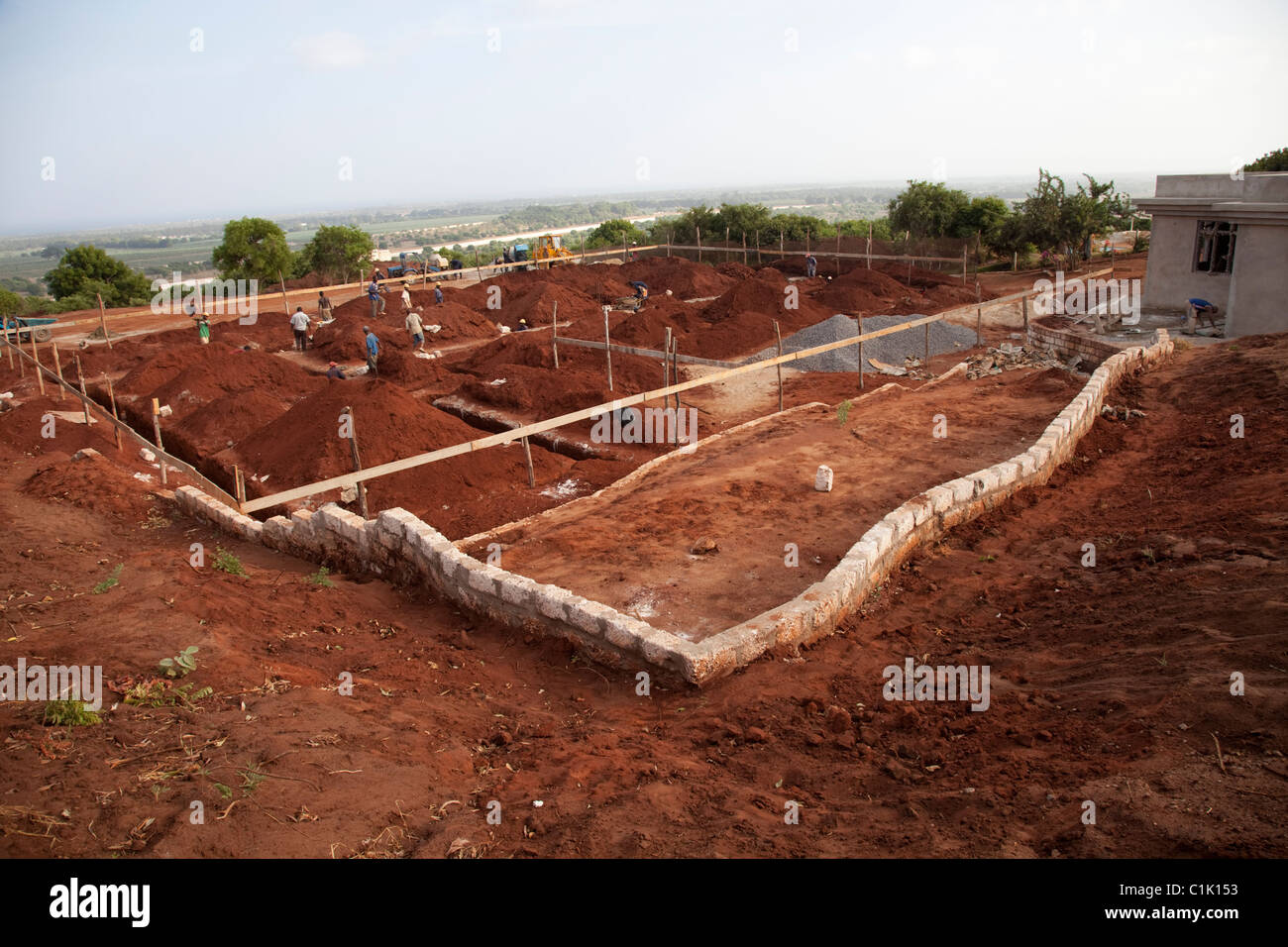 African builders preparing foundations large residential property