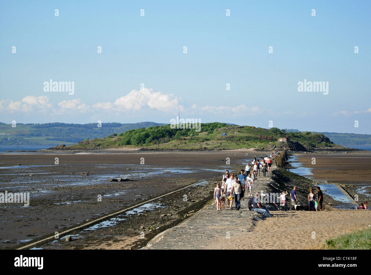 Walkers returning along the causeway from Cramond Island in the Firth