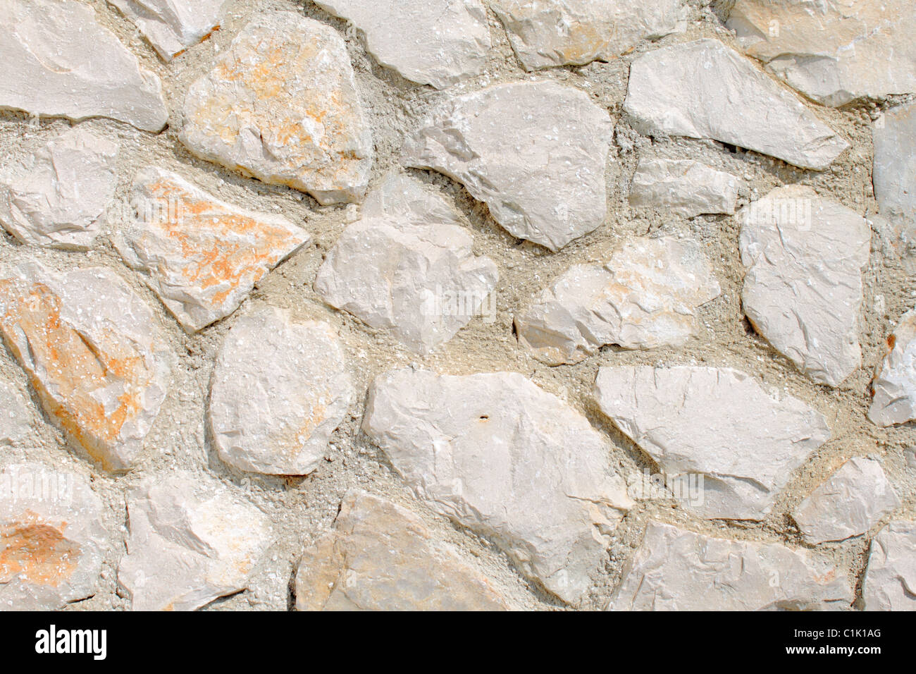 Rough stone wall background Stock Photo - Alamy