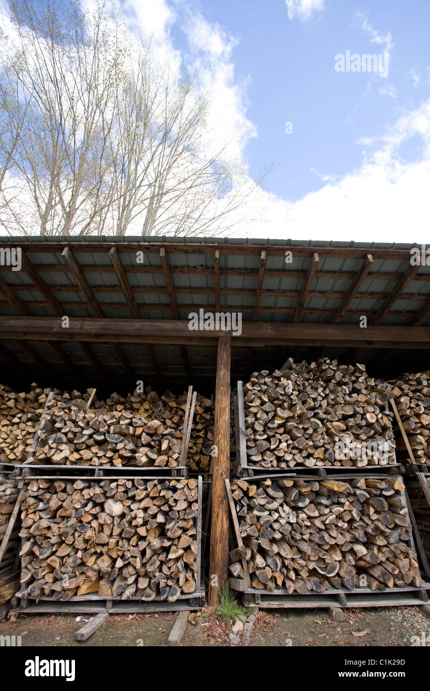 Wood is split and stacked waiting to be burned in the maple sugar house fire. Stock Photo