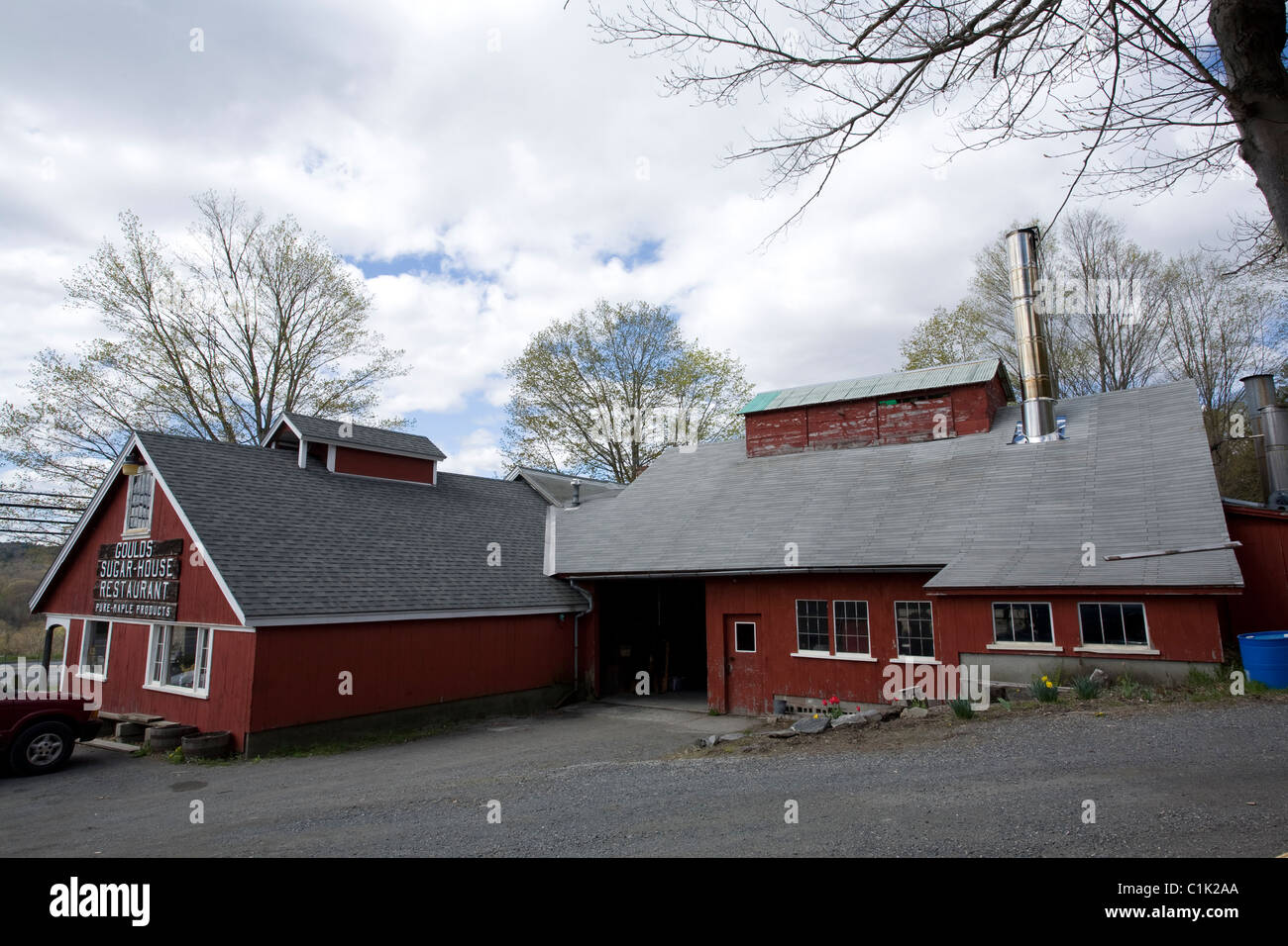 A New England sugar maple business has a restaurant as well as the sugar shed with tall stainless steel smoke stack. Stock Photo