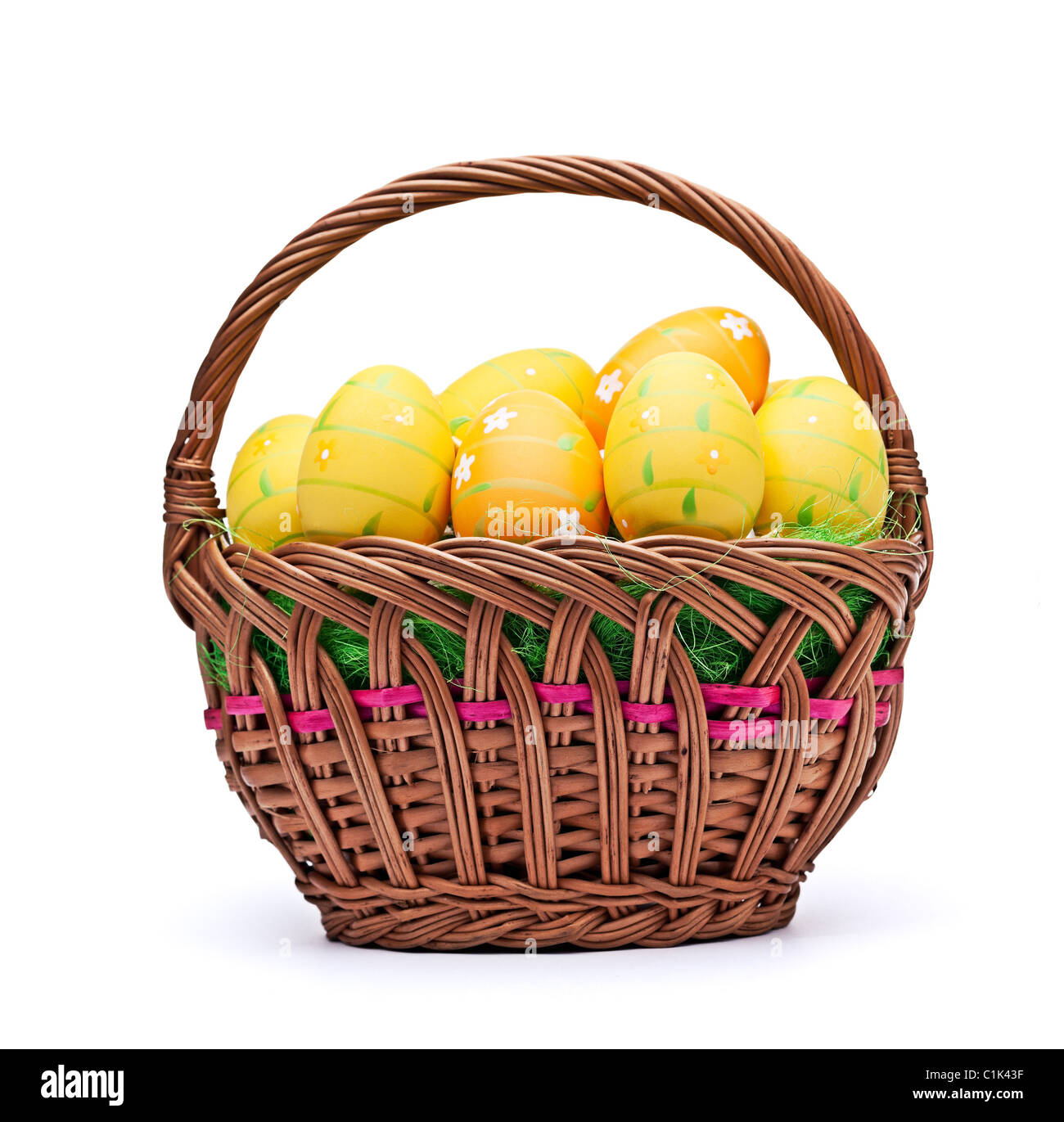 Woven basket full of eggs. Isolated on a white background. Stock Photo