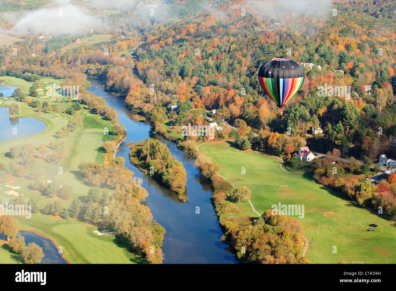 An aerial view of a hot air balloon floating over the Vermont country
