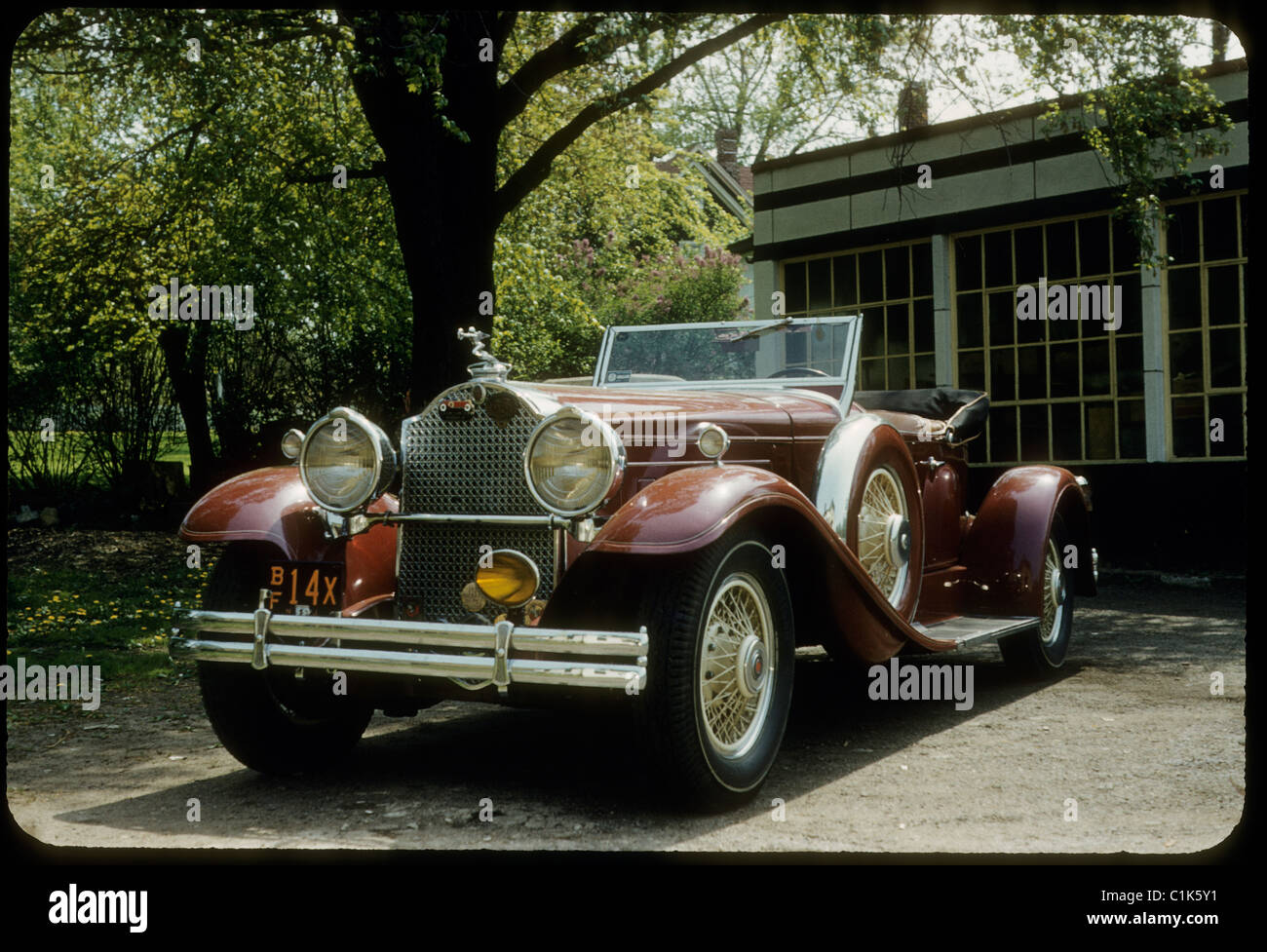 Antique car parked in front of home during 1950s Stock Photo
