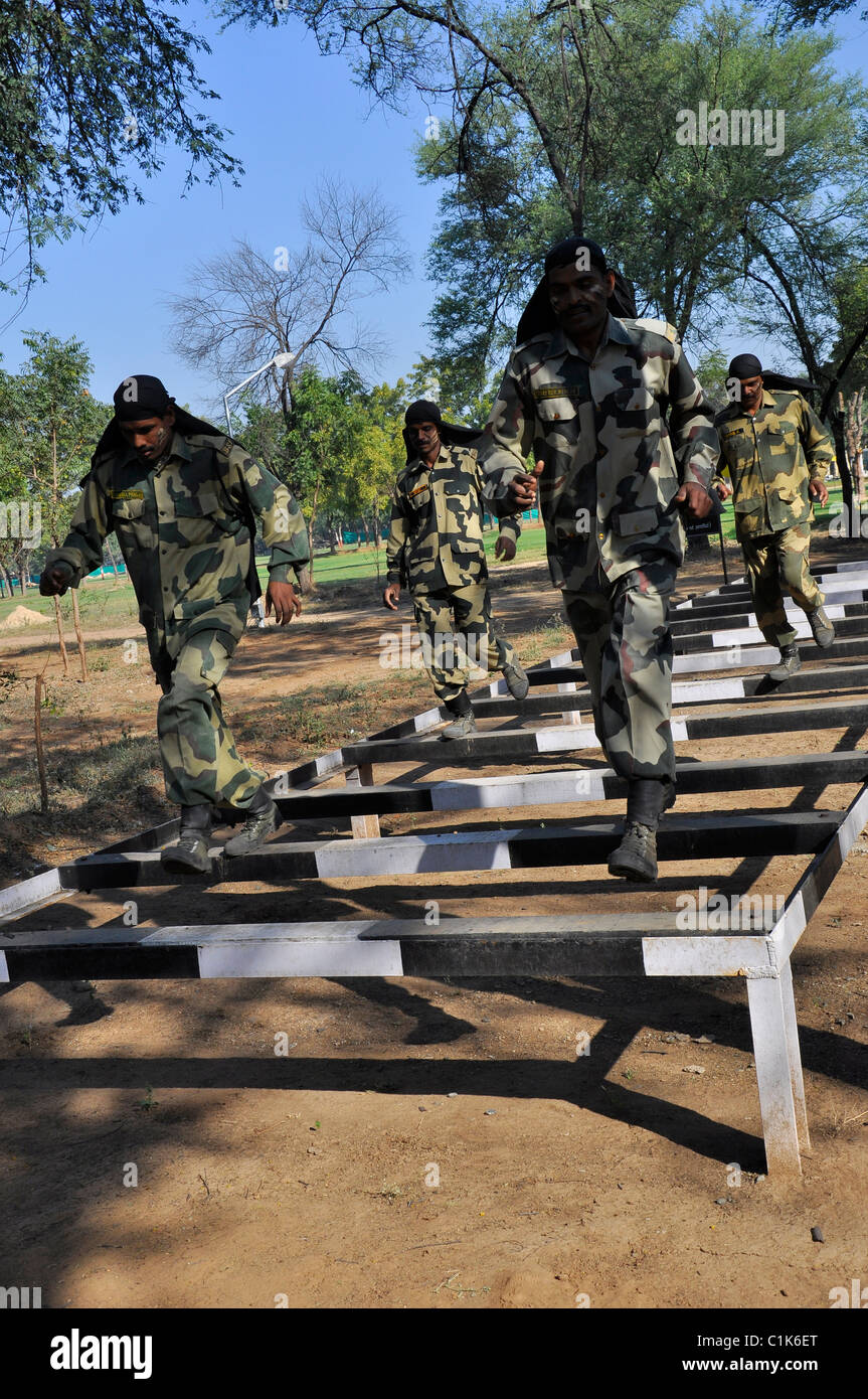 Soldiers running over an obstacle during a training Stock Photo