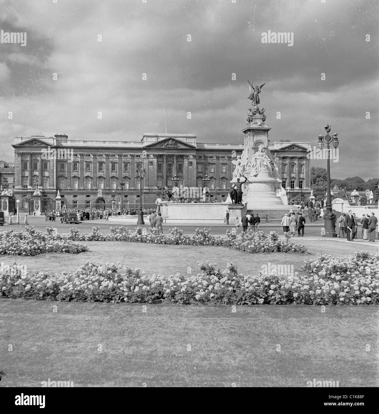 1950s, people at the Victoria Memorial on the Mall and at Buckingham Palace, a Royal Palace and the London residence of the British Royal family. Stock Photo