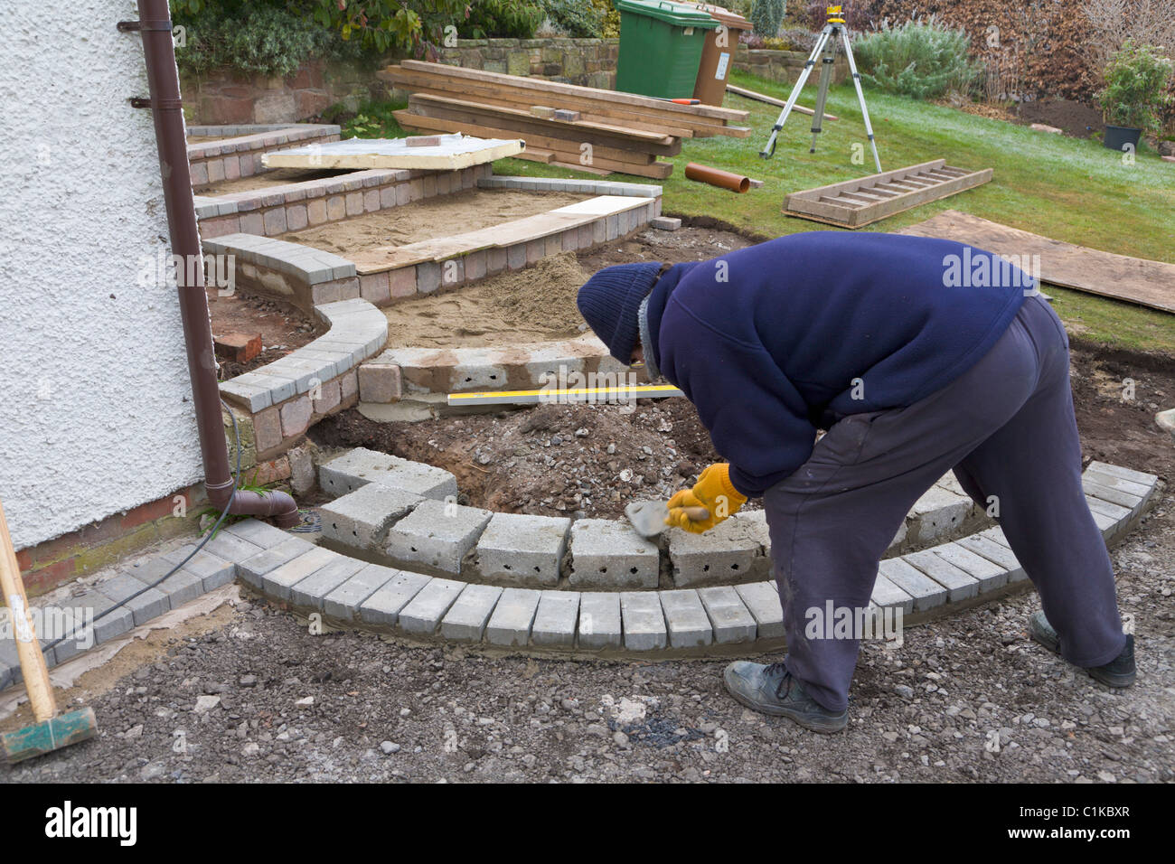 Builder laying block paving garden steps Stock Photo