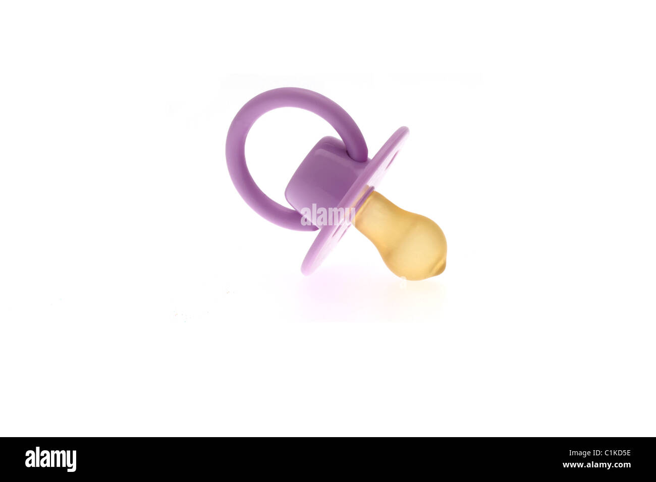 High key image of an infants purple dummy or pacifier taken against a white background. Stock Photo