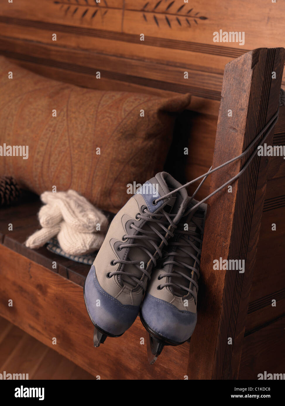 Pair of Ice Skates Hanging on Bench Stock Photo