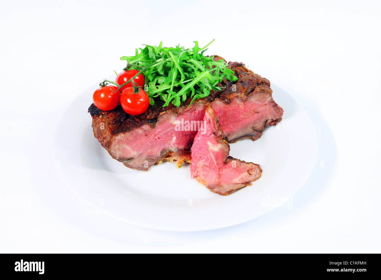 Roastbeef with gherkin and hot pepper on white background Stock Photo