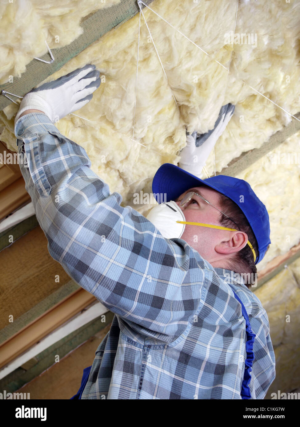 Worker thermally insulating a house attic using mineral wool Stock ...